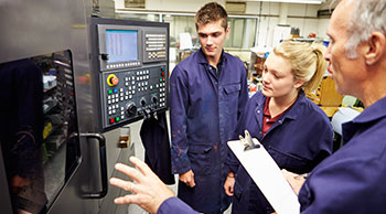 manager training two young apprentices