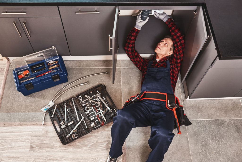 Guy Fixing a Sink