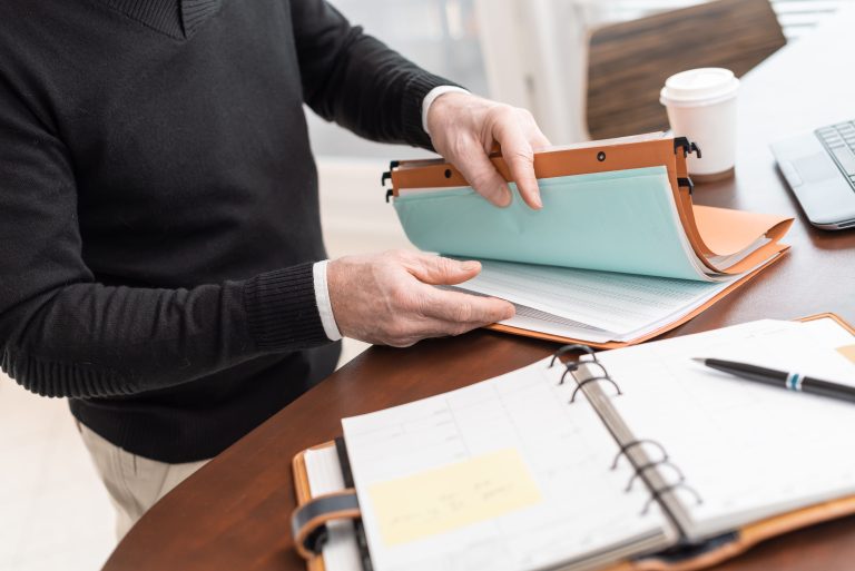 Businessman looking for document in folder